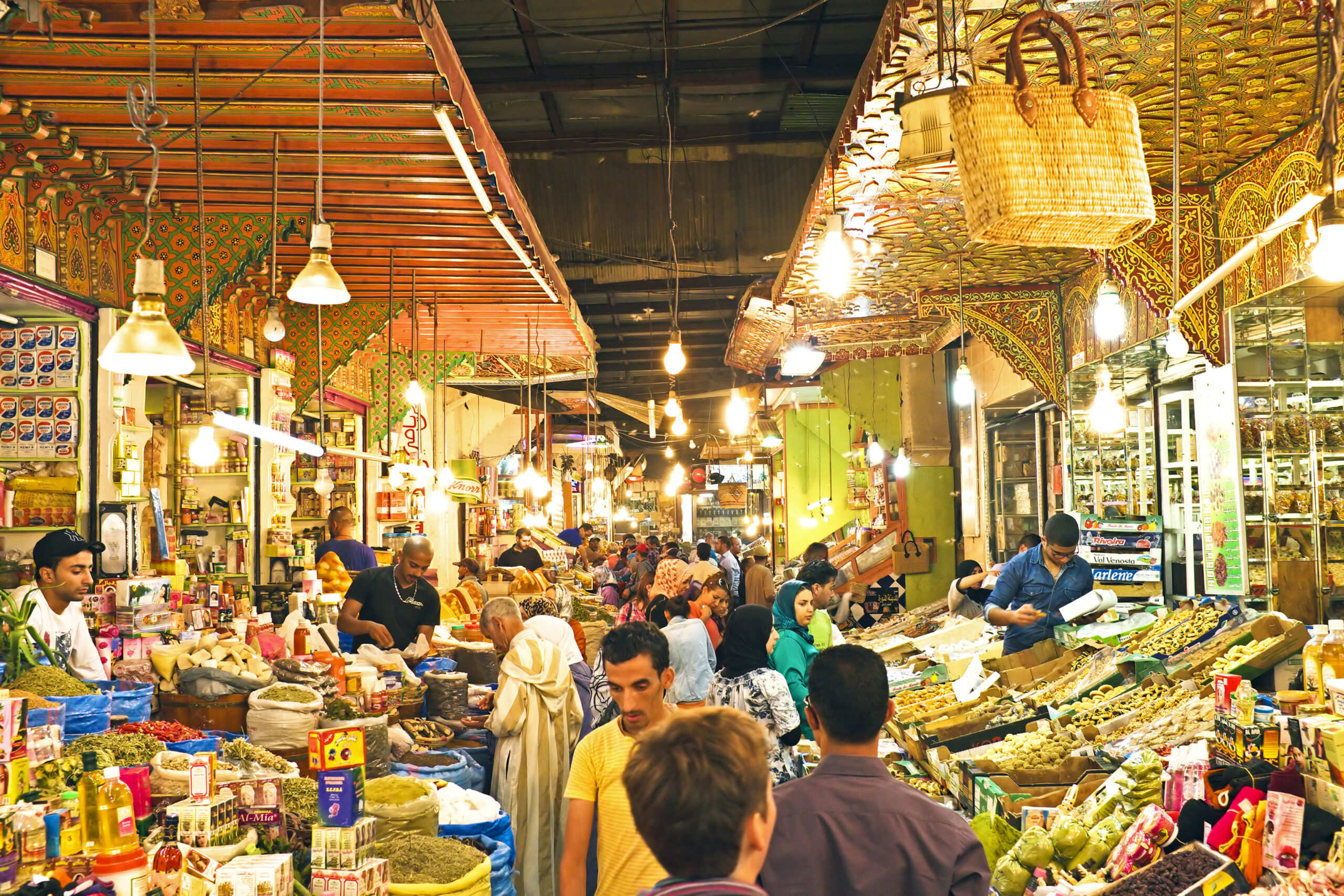 What to buy in Morocco — colorful spices, Berber carpets, and handcrafted souvenirs displayed in a traditional Moroccan souk