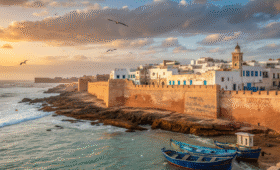 Essaouira day trip from Marrakech showing blue fishing boats in harbor with UNESCO medina and Atlantic coastline at golden hour