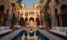 Luxury Hotels Marrakech Medina with traditional Moroccan architecture, fountain, and golden hour lighting