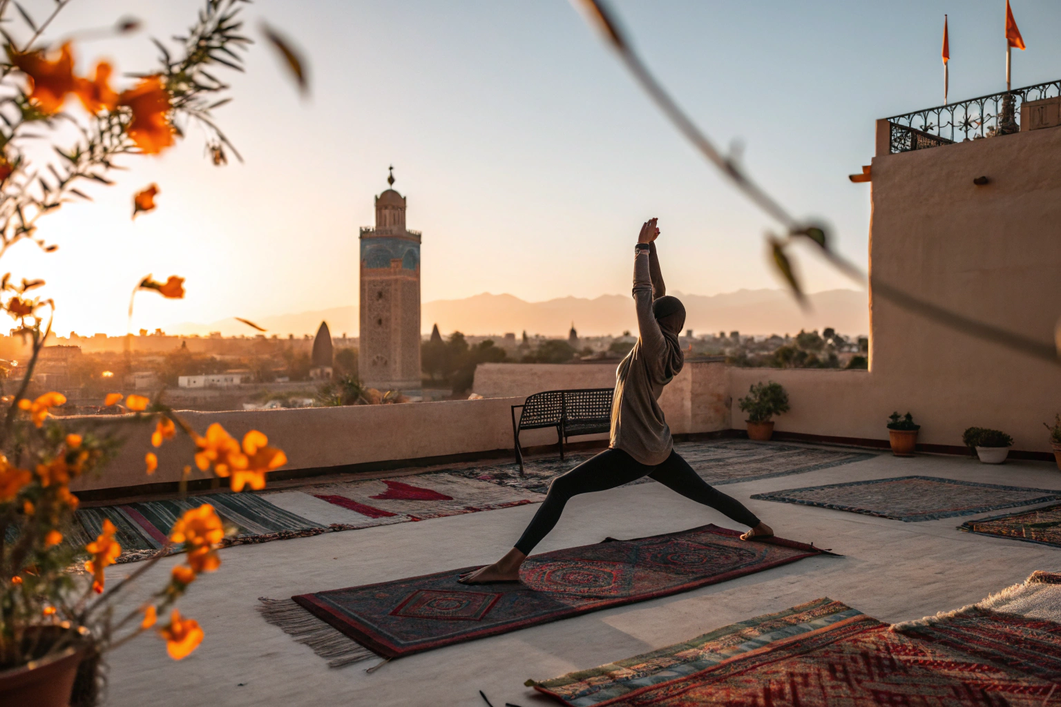 Sunrise yoga session on Marrakech rooftop with Koutoubia Mosque and Atlas Mountains, wellness retreat experience
