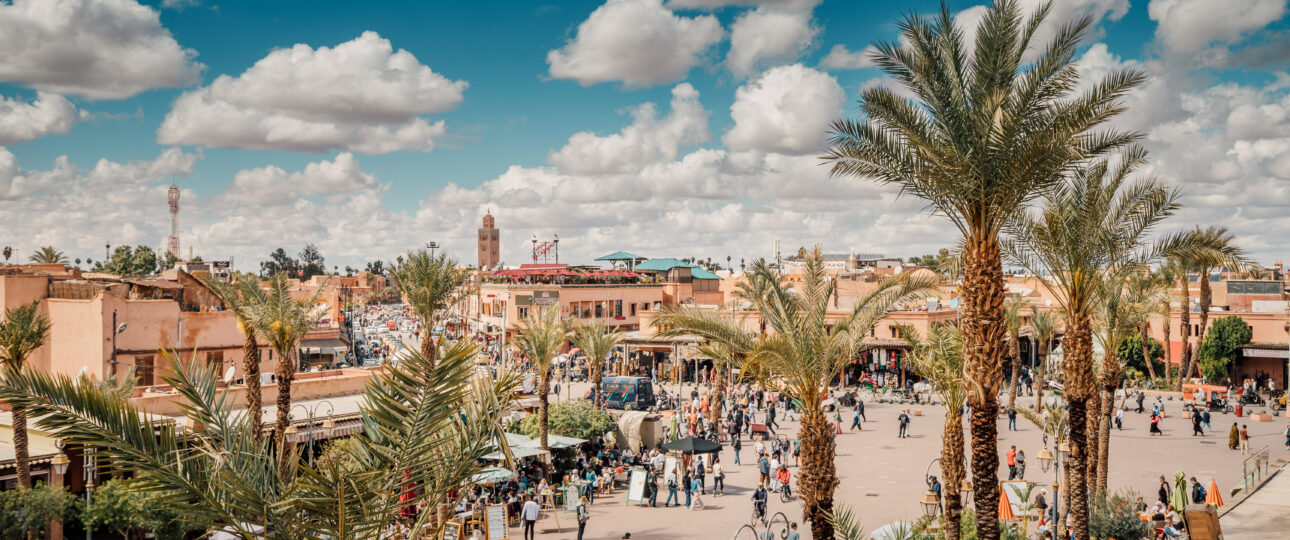 Aerial view of Marrakech Medina UNESCO World Heritage site with traditional souks and salmon-pink walls at sunset