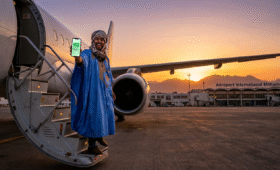 Traveler activating best eSIM for Morocco travel at Casablanca airport, ensuring seamless connectivity for exploring Marrakech souks and Sahara Desert, high-speed internet solution for worry-free adventures