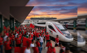 Exciting AFCON transport Morocco scene: fans with flags boarding Al Boraq train near Casablanca stadium, perfect for 2025 tournament travel between host cities like Rabat and Marrakech, inspiring seamless journeys across diverse Moroccan landscapes