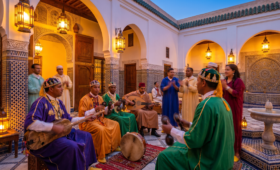 Gnawa musicians playing guembri and qraqeb in a traditional Moroccan riad courtyard with zellige tiles and lantern lighting at sunset.