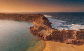 Are Morocco beaches swimmable? Aerial view of Mediterranean and Atlantic coastline showcases safe swimming conditions at Morocco sea beach with golden hour light