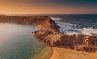 Are Morocco beaches swimmable? Aerial view of Mediterranean and Atlantic coastline showcases safe swimming conditions at Morocco sea beach with golden hour light