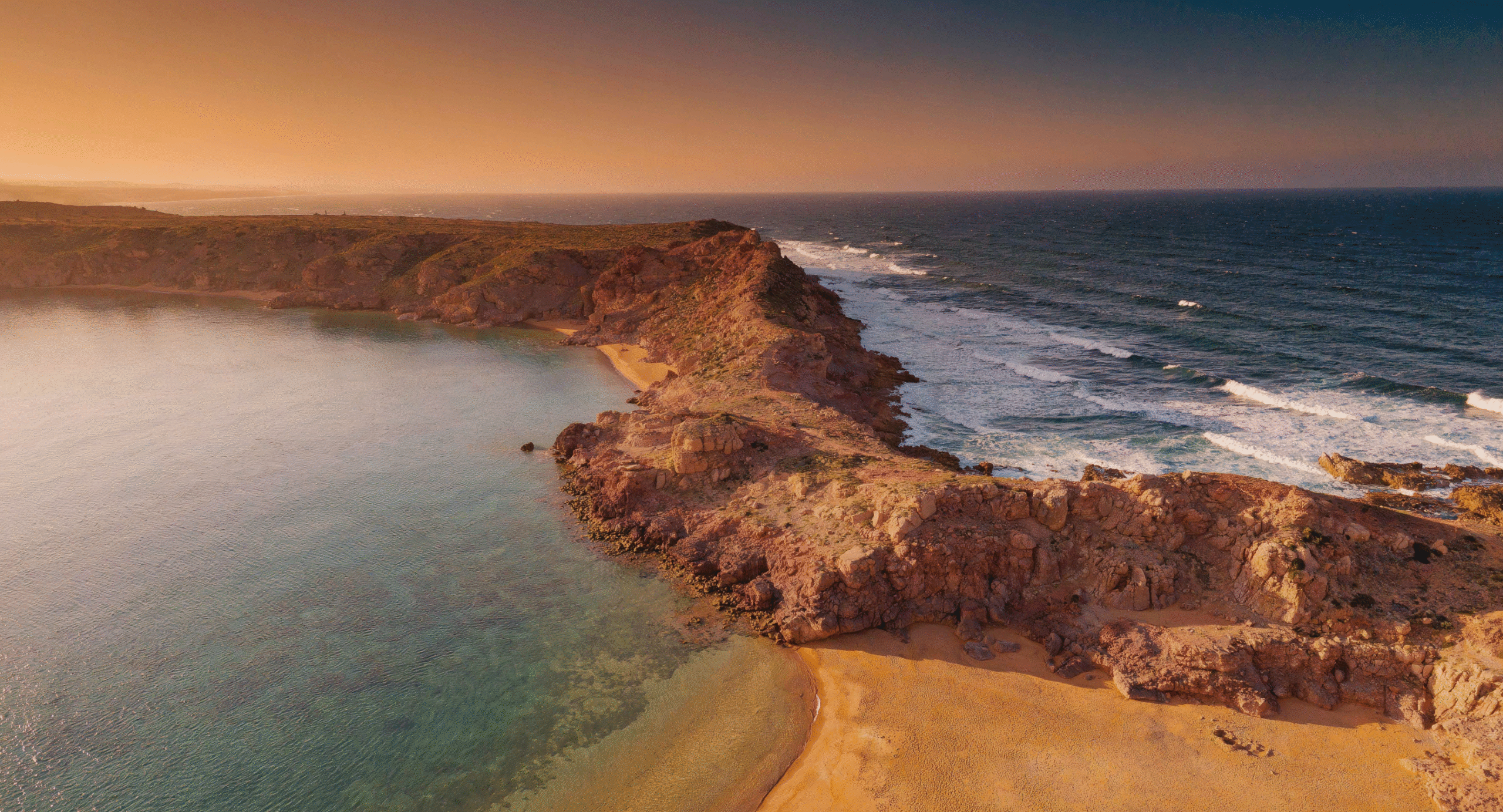 Are Morocco beaches swimmable? Aerial view of Mediterranean and Atlantic coastline showcases safe swimming conditions at Morocco sea beach with golden hour light.