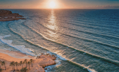 Morocco beach itinerary 7 days coastal adventure aerial sunset view of Taghazout Bay surfers and golden sand
