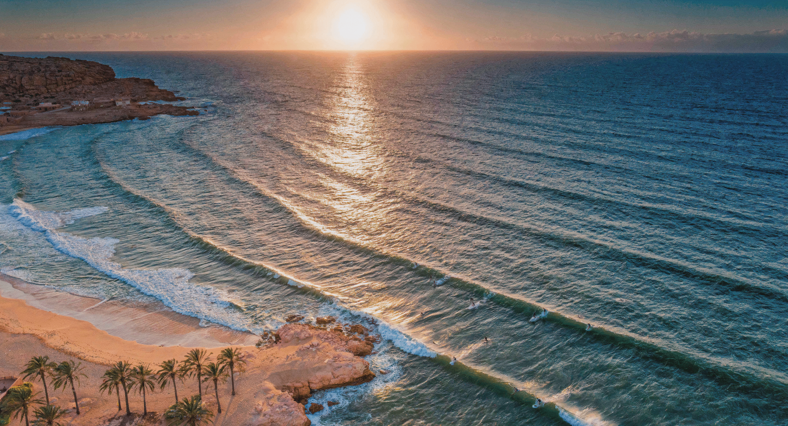 Morocco beach itinerary 7 days coastal adventure aerial sunset view of Taghazout Bay surfers and golden sand