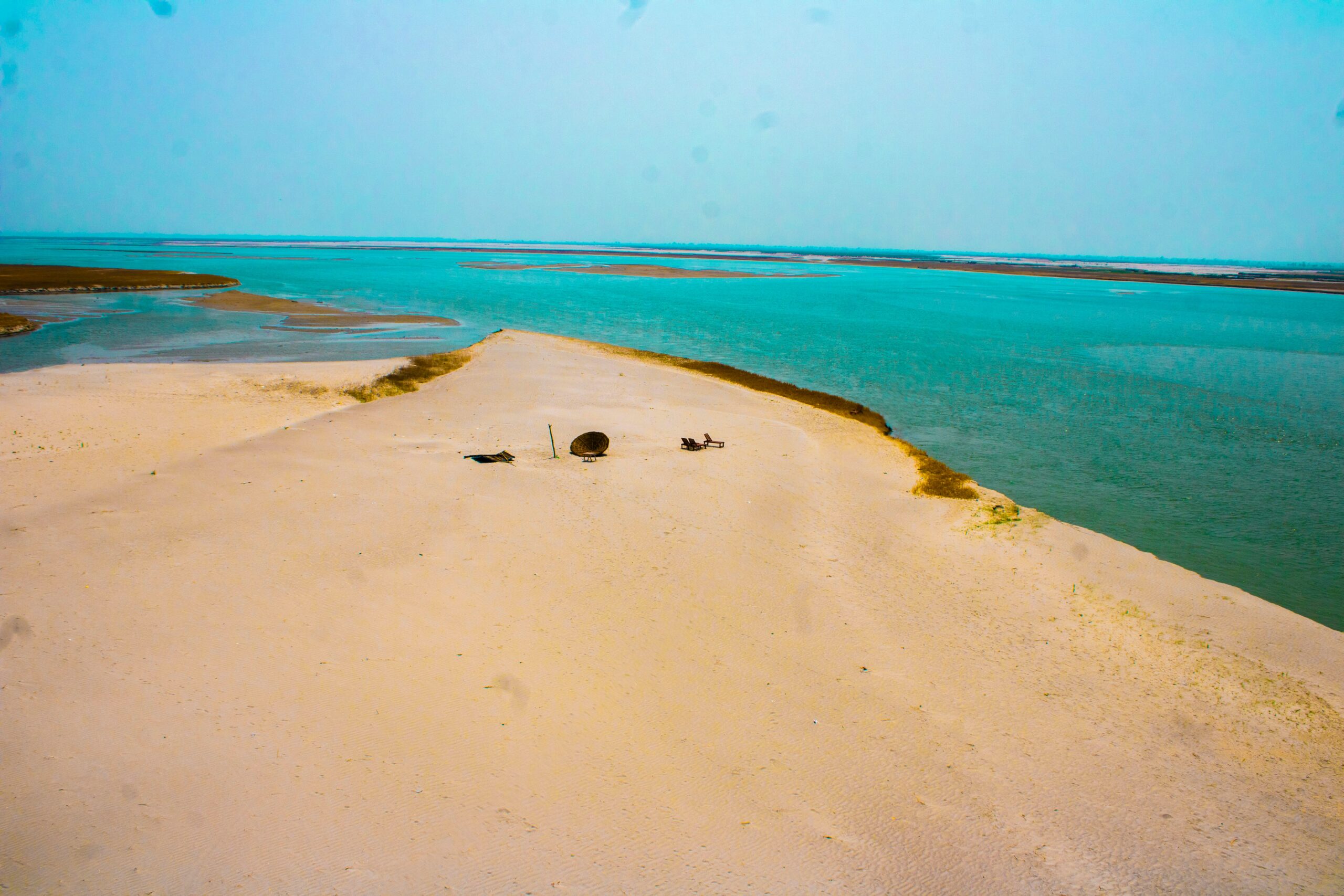 View from the White Dune over the Dakhla lagoon at golden hour with kites on the water