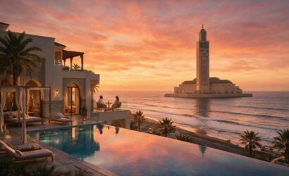 Luxury infinity pool at a Casablanca ocean-view resort overlooking the Atlantic at sunset with Hassan II Mosque silhouette