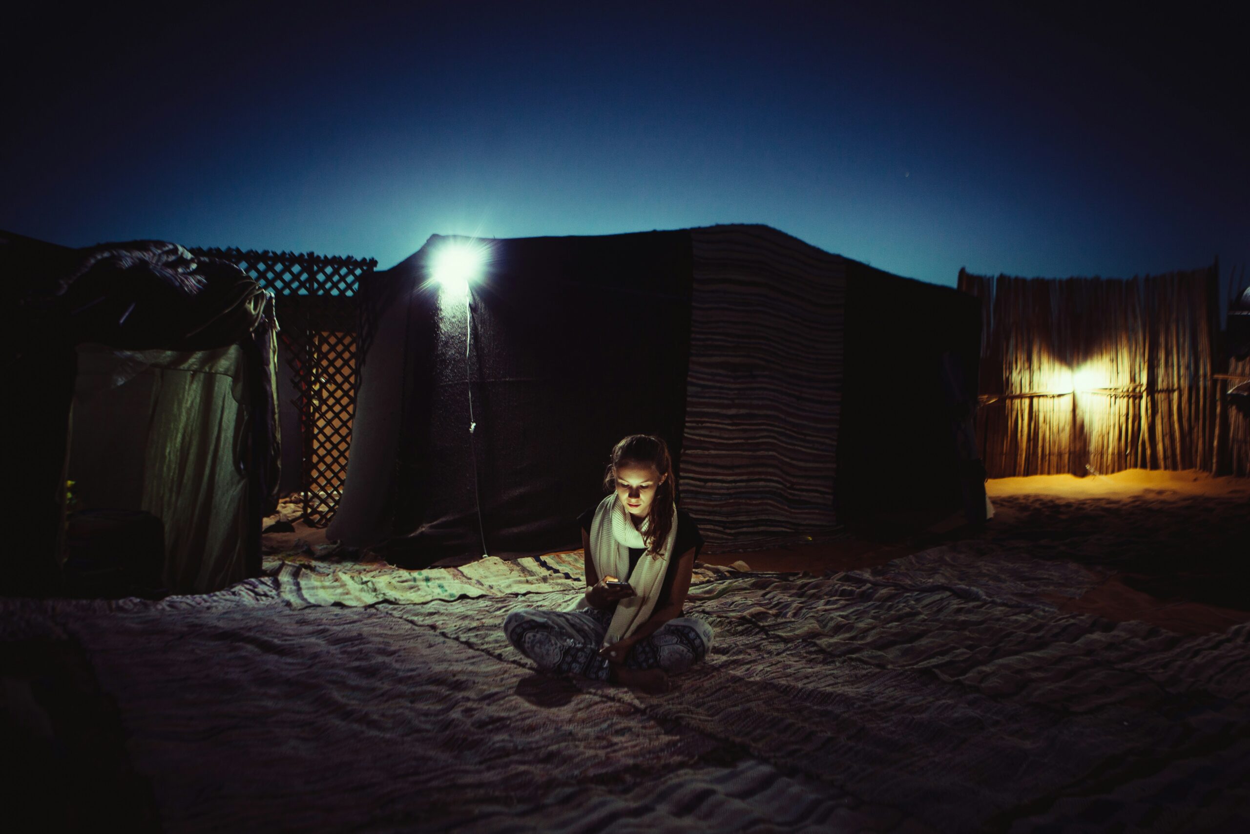 Desert camp glowing under a starry sky in Merzouga, Morocco