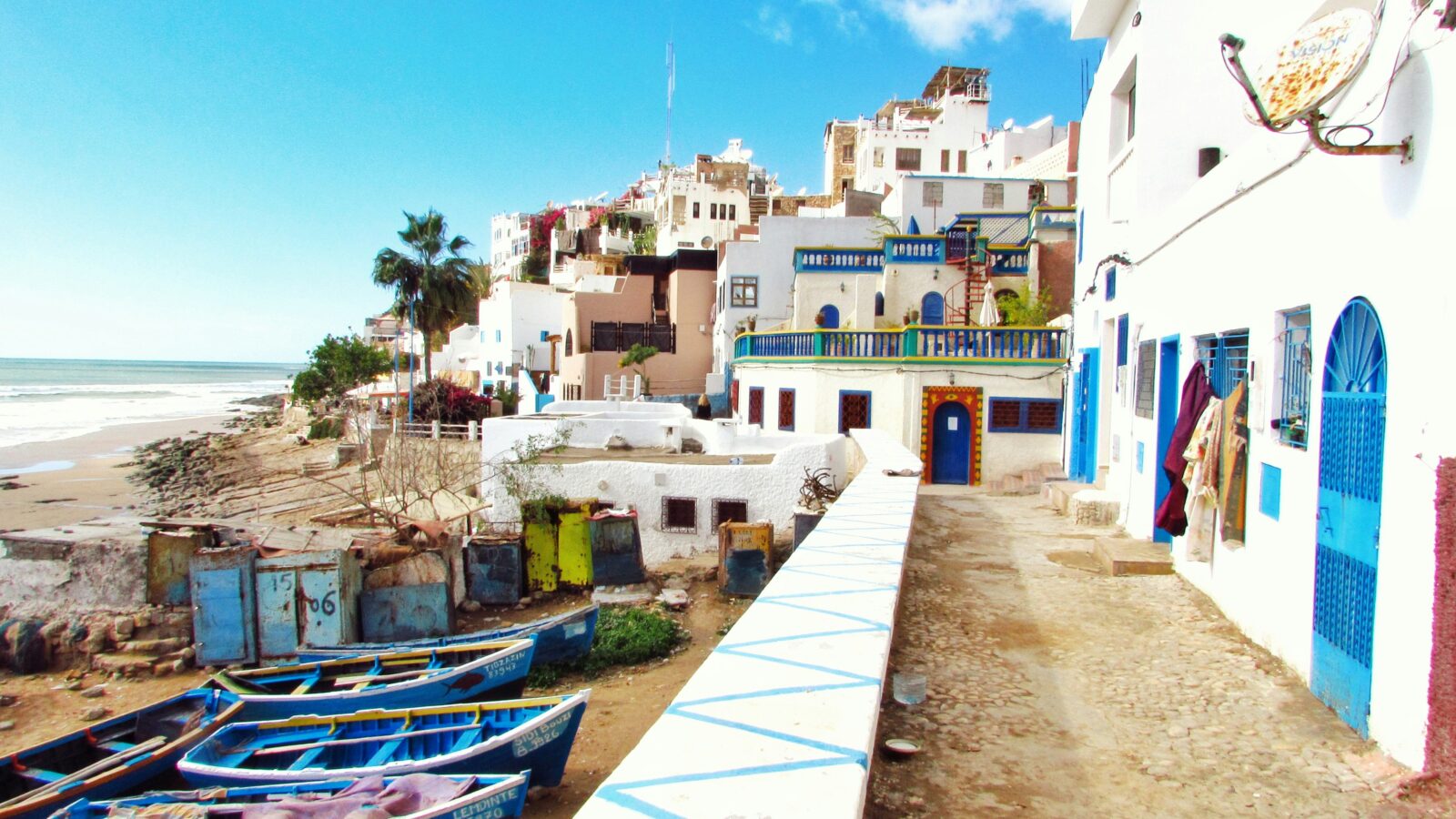 A picturesque waterfront scene with a row of boats docked along the shore